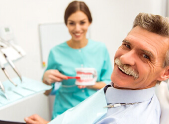 elderly man at a dentures consultation