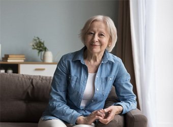 a woman with dentures smiling and relaxed