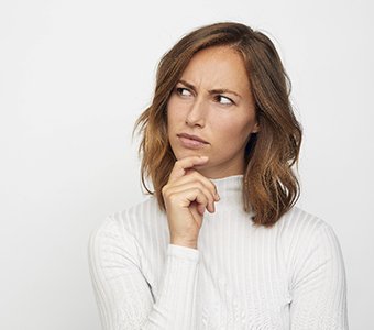 A woman thinking about visiting a cosmetic dentist in Falmouth.