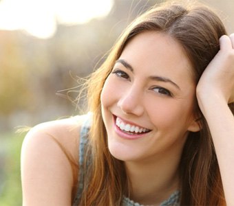 woman smiling after getting dental bridge in Falmouth