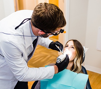 A man and woman shaking hands with a dental staff member