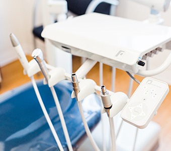 A dental hygienist cleaning a female patient’s teeth