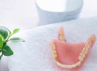 pair of dentures sitting atop a towel