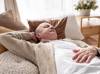 a mature man sleeping without his dentures