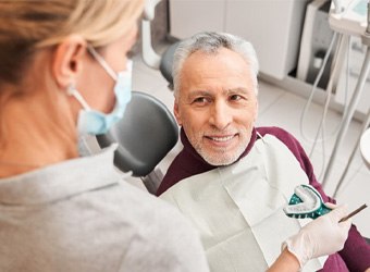 a patient visiting his dentist for dentures aftercare