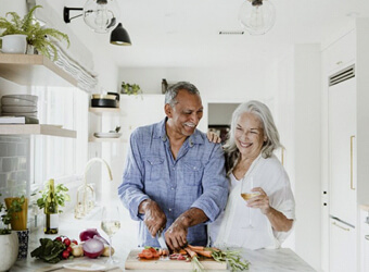 elderly couple cooking in a kitchen