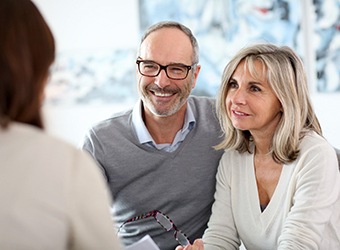 senior couple talking to their denture dentist in Falmouth 