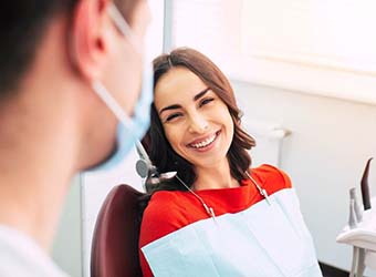 dental patient smiling at her dentist