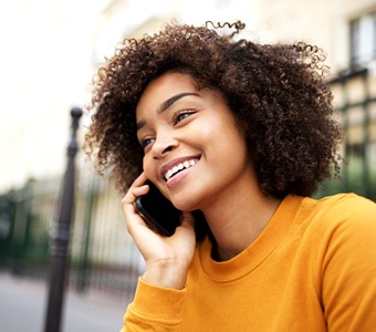 Smiling woman outside talking on phone
