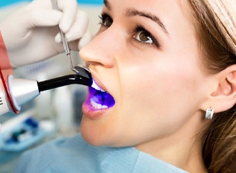 woman getting a tooth-colored filling from her dentist in Falmouth