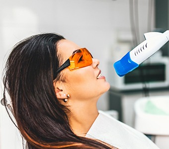 A woman receiving teeth whitening in Falmouth.