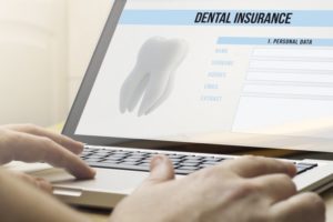 Person using computer to shop for dental insurance online