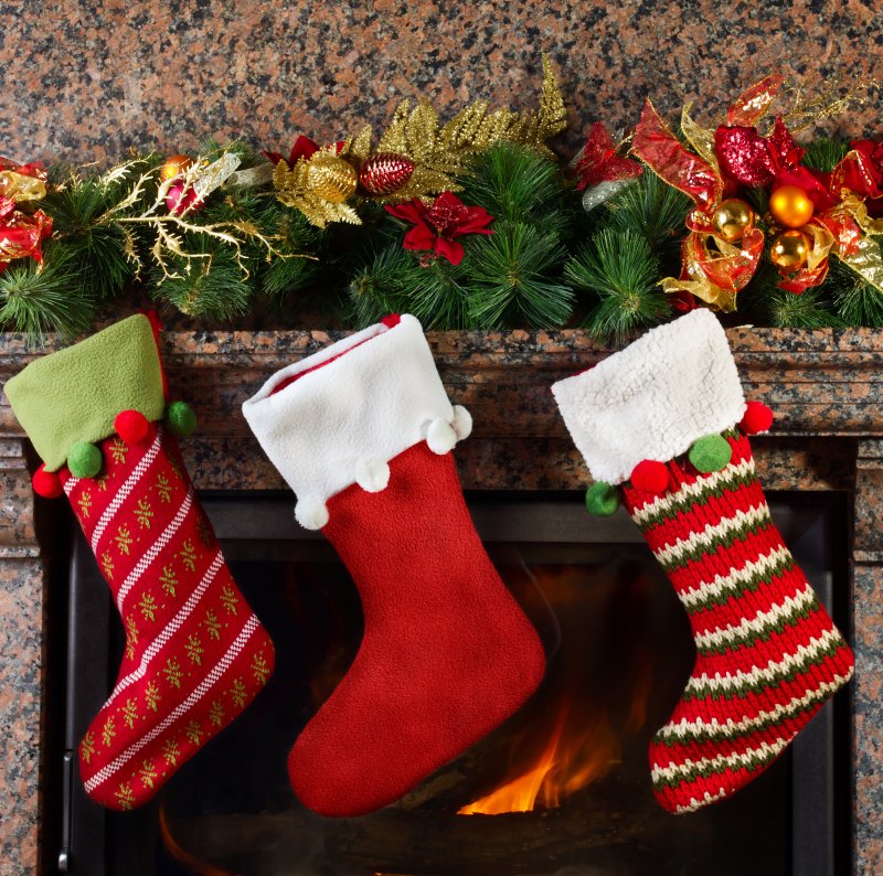 an image of three holiday stockings hung on the mantle