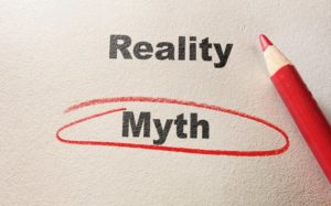 a piece of paper with the words "reality" and "myth written on it and "myth" is circled with a red colored pencil 