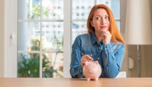 woman thinking about what to do with her tax refund