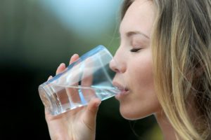 Woman drinking fluoride in drinking water