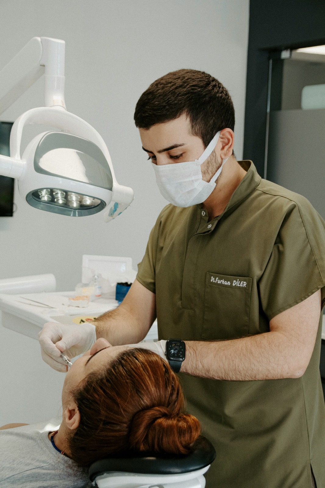 Dentist examining a patient reclined in the treatment chair