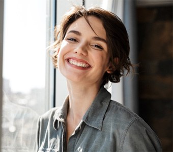 Patient smiling after receiving a dental bridge at Casco Bay Smiles in Falmouth, ME