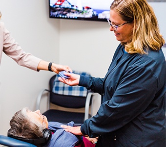 Dental hygienist reviewing care with a patient at Casco Bay Smiles